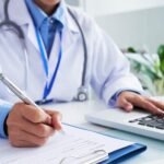 general physician near me is writing prescription for a patient